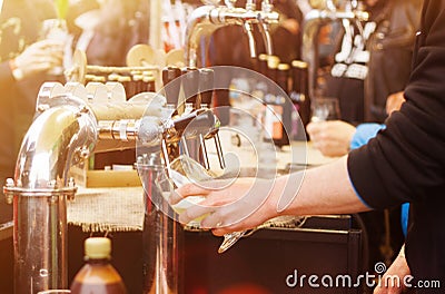 Beer cranes and blurred people in the street food festival Stock Photo