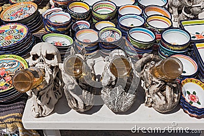 Beer drinking figures between colored ceramic bowls at a stall in mahahual, quintana roo, mexico Editorial Stock Photo