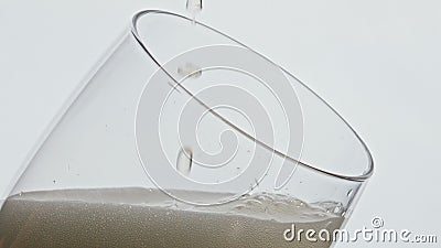 Beer drops falling glass closeup. Alcoholic liquid blob dripping at hoppy lager Stock Photo