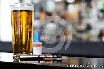 Beer, e-liquid and vaporizer on the bar Stock Photo