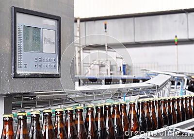 Beer filling in a brewery - conveyor belt with glass bottles Stock Photo