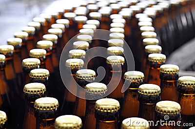 Beer filling in a brewery - conveyor belt with glass bottles Stock Photo