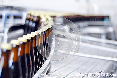 Beer filling in a brewery - conveyor belt with glass bottles Stock Photo