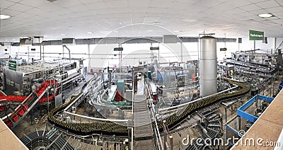 Beer filling in a brewery - conveyor belt with glass bottles Stock Photo