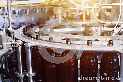 Beer filling line close-up. Beer filling process in an automatic line. Stock Photo