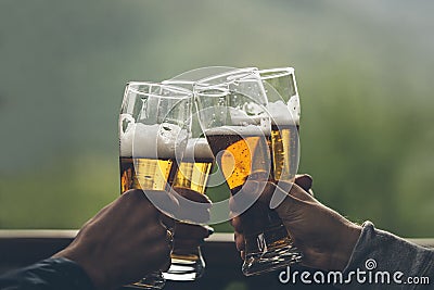 Beer with foam light tall boys in the hands of friends raising a Stock Photo