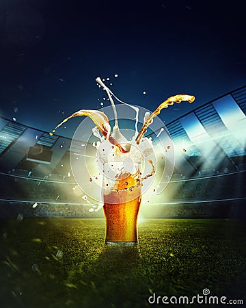 Beer and foam splashes. Mug with lager beer standing on grass at football stadium over evening sky with flashlights Stock Photo