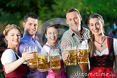 In Beer garden - friends drinking beer Stock Photo