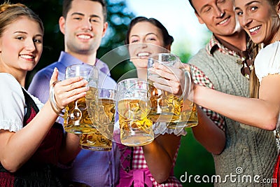 In Beer garden - friends drinking beer Stock Photo