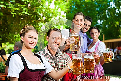 In Beer garden - friends drinking beer Stock Photo