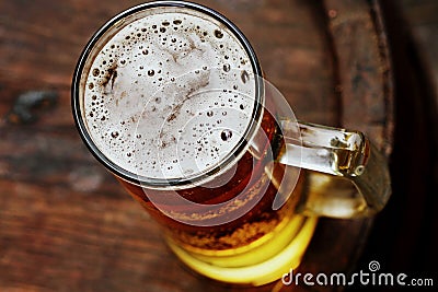 Beer glass on wooden barrel Stock Photo