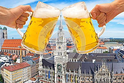 Beer mugs cheers with Munich Marienplatz in background Stock Photo
