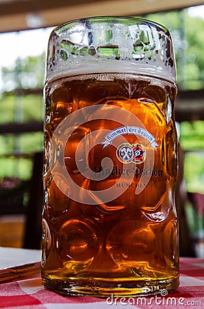Beer Mug with logo on the table in the Hacker-Pschorr brewery Editorial Stock Photo