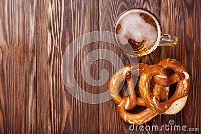 Beer mug and pretzel on wooden table Stock Photo