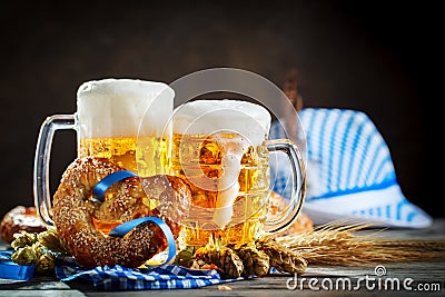 Beer mugs and pretzels on a wooden table. Oktoberfest. Beer festival. Stock Photo