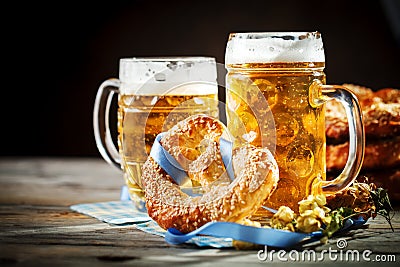 Beer mugs and pretzels on a wooden table. Oktoberfest. Beer festival. Stock Photo