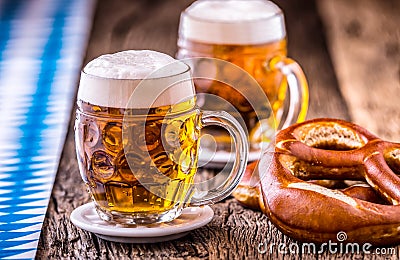 Beer. Oktoberfest.Two cold beers and pretzel. Draft beer. But draft. Golden beer. Golden however. Stock Photo