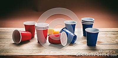 Beer pong. Plastic red and blue color cups and ping pong balls on wood, banner Stock Photo