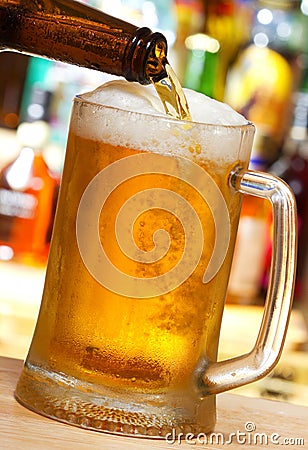 Beer pouring into mug Stock Photo