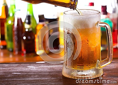 Beer pouring into mug Stock Photo