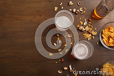 Beer and relaxation. Ale in bottles and glasses, chips, nuts and pistachios Stock Photo