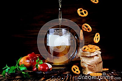 Beer with sausages grilled and salty pretzel Stock Photo