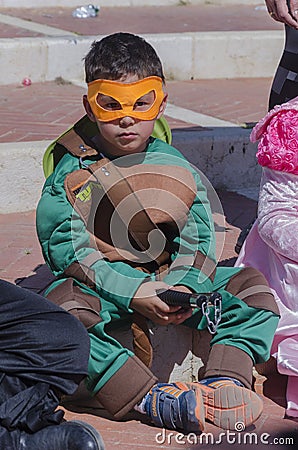 Beer-Sheva, ISRAEL - March 5, 2015: A boy in a green suit ninja turtle in the yellow mask Editorial Stock Photo