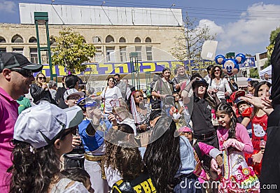 Beer-Sheva, ISRAEL - March 5, 2015: Children in carnival costumes catch the gifts on the Feast of Purim- Editorial Stock Photo