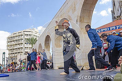 Beer-Sheva, ISRAEL - March 5, 2015: Dance group male dancers on the open stage of the city - Purim Editorial Stock Photo
