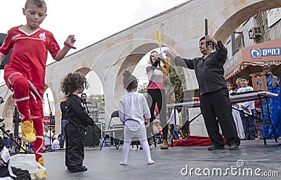 Beer-Sheva, ISRAEL - March 5, 2015: Speech at the street scene of artists and children viewers -Purim Editorial Stock Photo