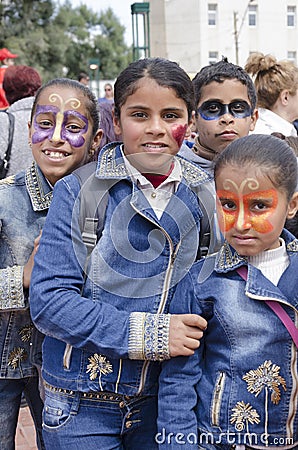 Beer-Sheva, ISRAEL - March 5, 2015:Three teenage girls and a boy in denim dress with carnival makeup on their faces - Purim Editorial Stock Photo