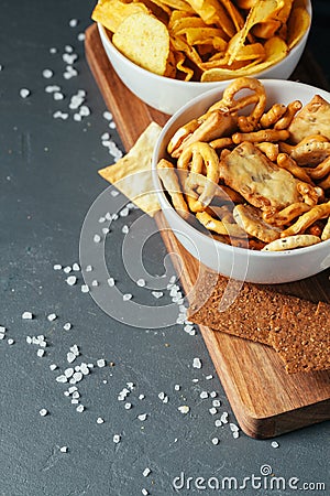 Beer snacks on stone table. Various crackers, potato chips. Top view Stock Photo