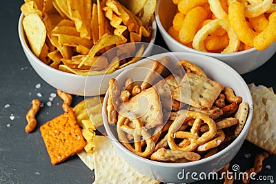 Beer snacks on stone table. Various crackers, potato chips. Top view Stock Photo