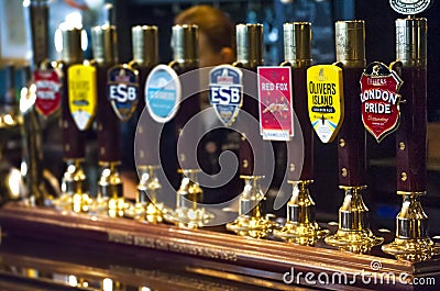Beer taps in British Pub Editorial Stock Photo