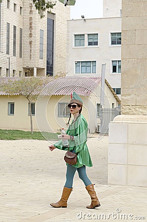 Beersheba, Israel - Ð woman in a green suit on the street. Purim Editorial Stock Photo