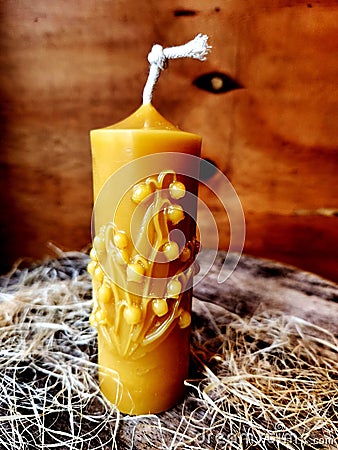 Beeswax handmade candle. Candle pillar beeswax and flowers. Stock Photo