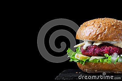 Beet burger with lettuce, cheese and yogurt sauce. Copy space Stock Photo
