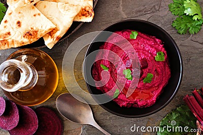Beet hummus dip, top view scene with flat bread and ingredients Stock Photo