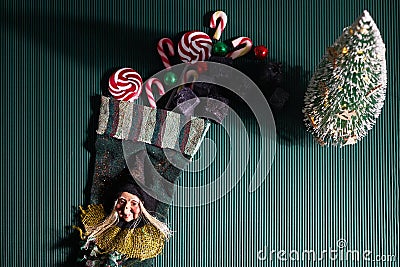 Befana sock with sweet coal and candy on dark greeen background. Italian Epiphany day tradition. Stock Photo