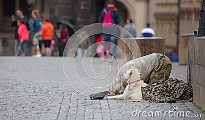 Beggar with dog begging for alms on the street in Prague Editorial Stock Photo