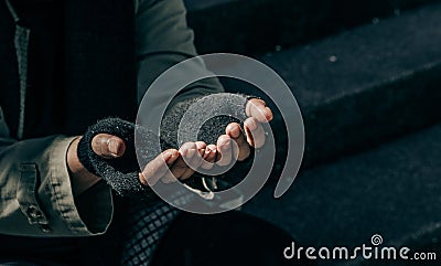 Beggar,Hand of Homeless adult man seeking help on the park. Stock Photo