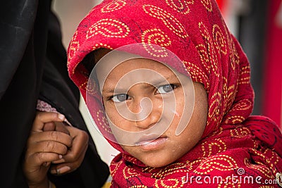 Beggar indian girl begs for money from a passerby in Srinagar, Kashmir. India Editorial Stock Photo