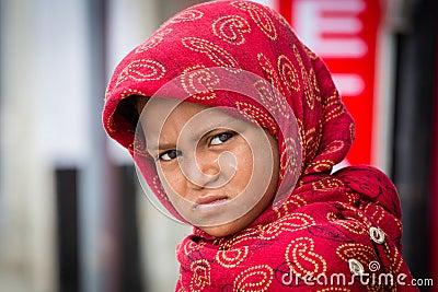 Beggar indian girl begs for money from a passerby in Srinagar, Kashmir. India Editorial Stock Photo