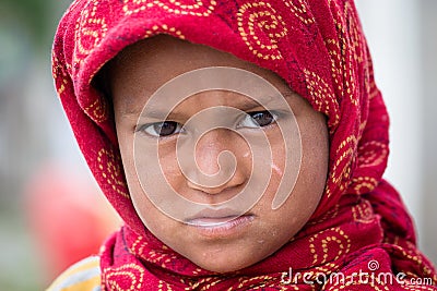 Beggar indian girl begs for money from a passerby in Srinagar, Kashmir. India Editorial Stock Photo