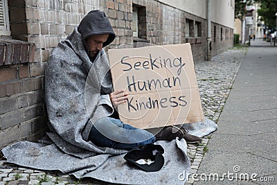 Beggar Showing Seeking Human Kindness Sign On Cardboard Stock Photo