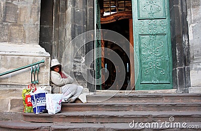 Beggar woman sitting on the doorstep Editorial Stock Photo