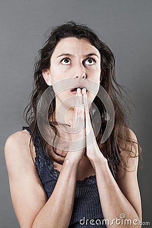 Begging desperate 30s woman praying for help or miracle Stock Photo