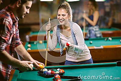 Beginning billiard game - man and woman flirting while playing snooker Stock Photo