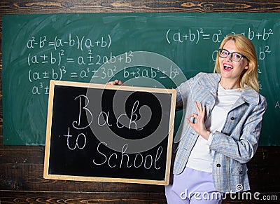 Beginning of new school season. Woman teacher holds blackboard inscription back to school. Are you ready to study. Lady Stock Photo