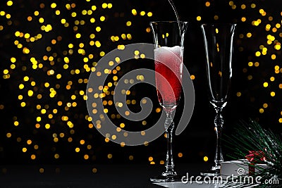 The beginning of a New Year's Eve or Christmas party. Pouring champagne into a glass without people. The champagne Stock Photo
